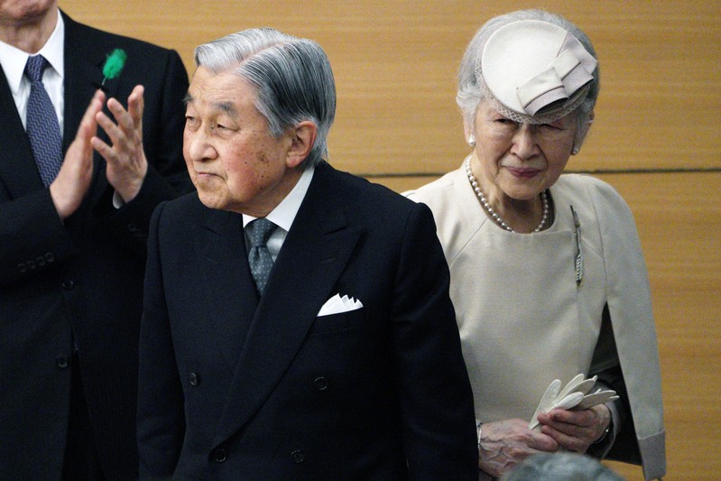 Japan's Emperor Akihito and Empress Michiko greet the guests as they leave from the stage after the awarding ceremony of the Midori Academic Prize in Tokyo.