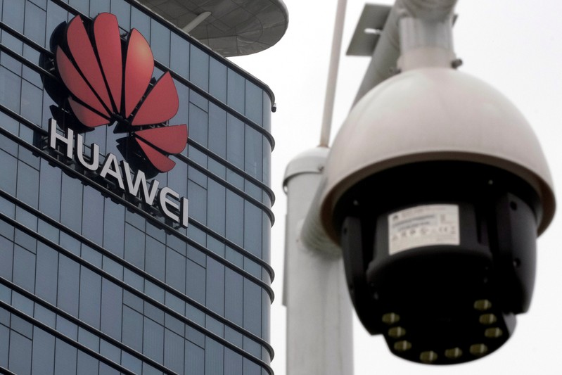 FILE PHOTO: A surveillance camera is seen in front of Huawei logo outside its factory campus in Dongguan, Guangdong province