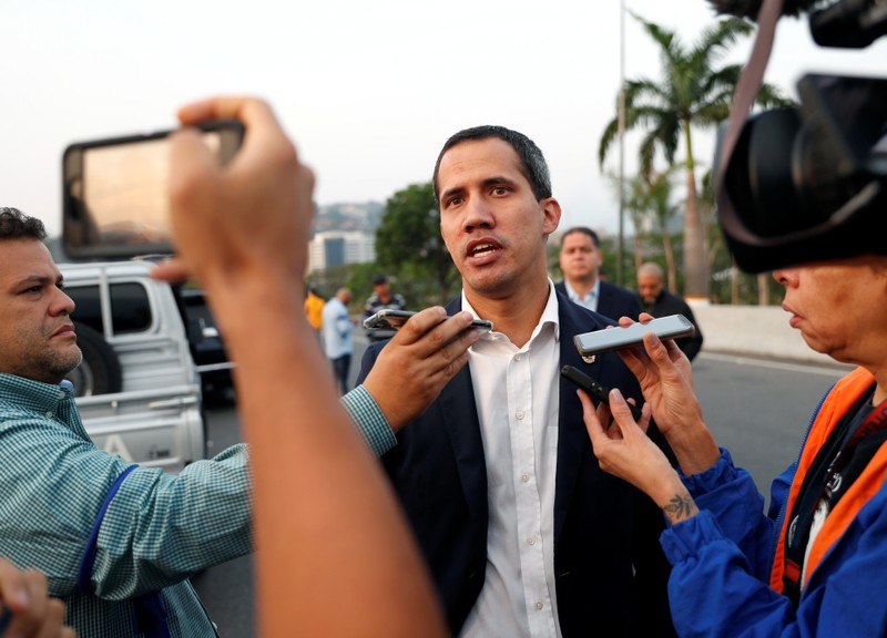 Venezuelan opposition leader Juan Guaido talks to the media outside Generalisimo Francisco de Miranda Airbase in Caracas