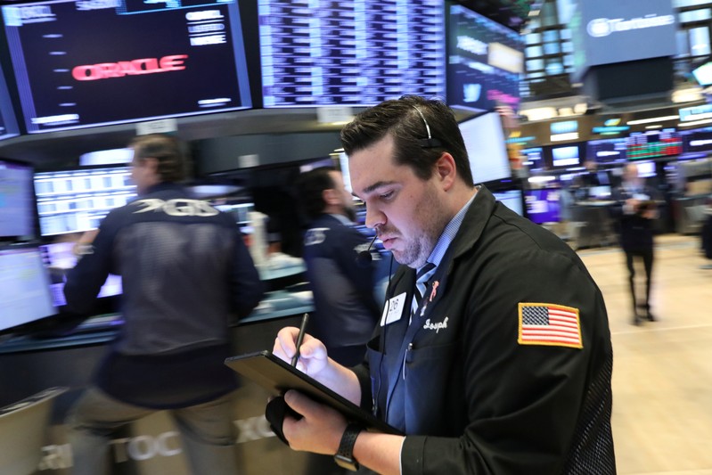 Traders work on the floor at the NYSE in New York