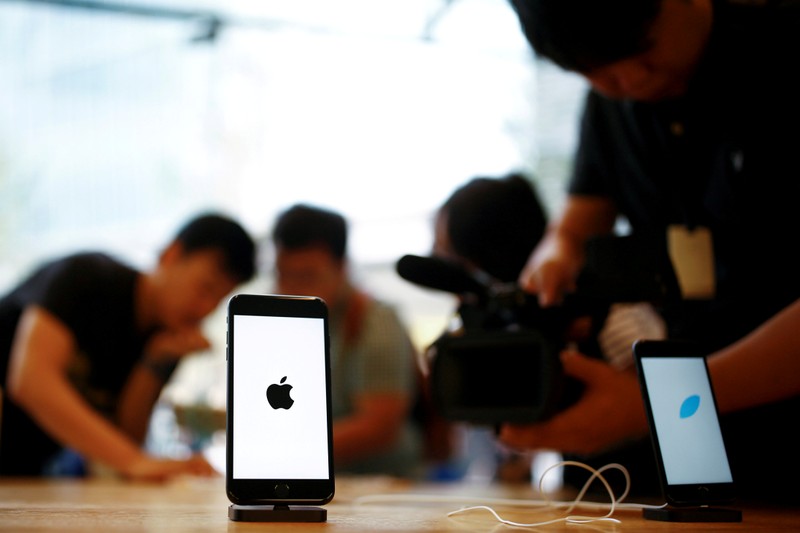 FILE PHOTO: Members of the media film the new iPhone 7 at an Apple store in Beijing