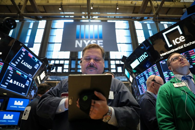 Traders work on the floor at the NYSE in New York