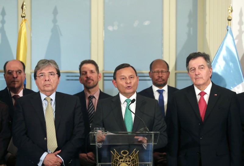 Peru's Foreign Minister Nestor Popolizio makes declarations to the media next to Chile's Foreign Minister Roberto Ampuero and Colombia's Foreign Minister Carlos Holmes Trujillo after a Lima Group regional bloc summit in Lima