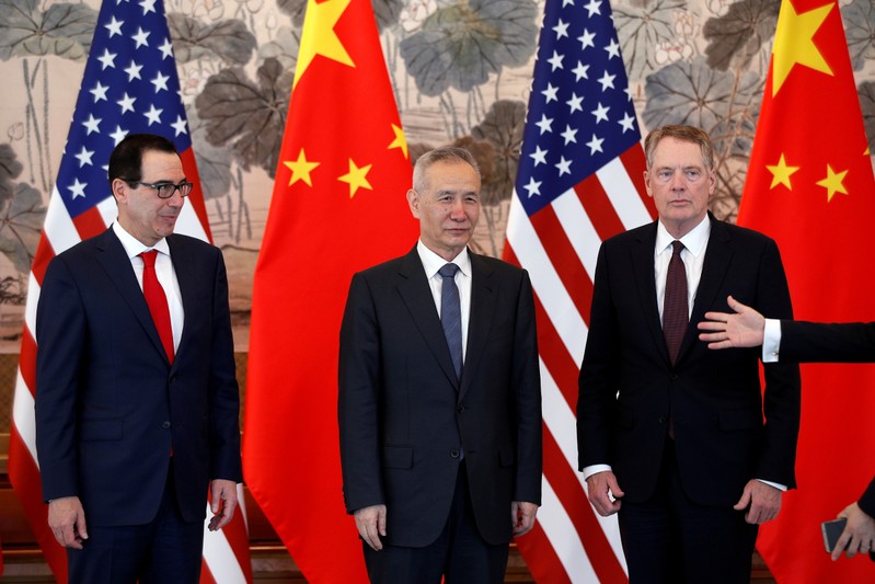 FILE PHOTO: Chinese Vice Premier Liu He, U.S. Treasury Secretary Steven Mnuchin and U.S. Trade Representative Robert Lighthizer arrive for a group photo session after concluding their meeting at the Diaoyutai State Guesthouse in Beijing