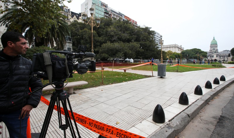 A cameraman works at the crime scene where Argentine Congressman Hector Olivares was injured and his adviser, Miguel Yadon, was killed in an attack near the National Congress in Buenos Aires