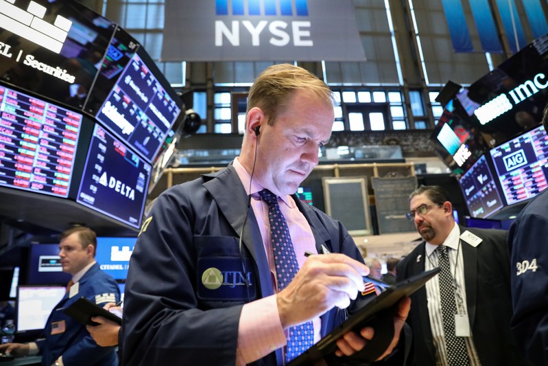 Traders work on the floor at the NYSE in New York