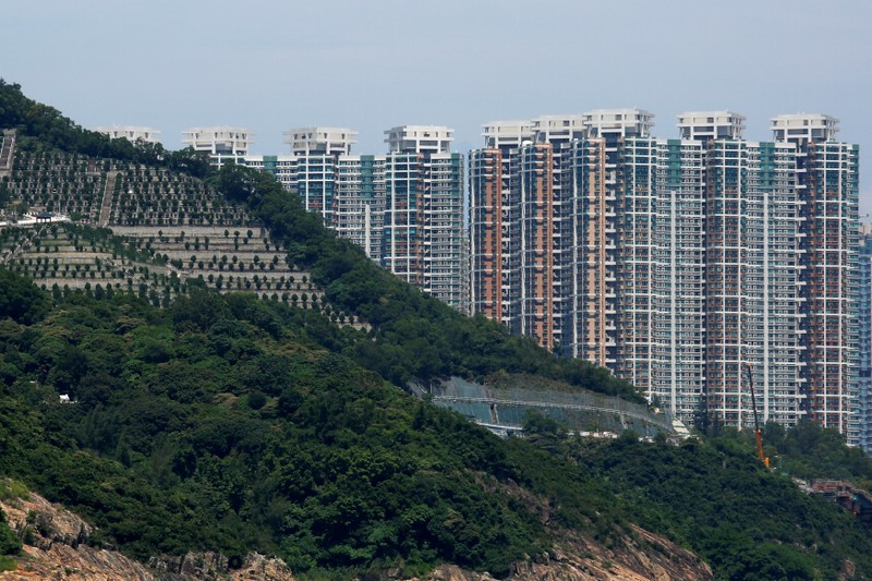 FILE PHOTO: Private residential blocks are seen behind a cemetery in Hong Kong