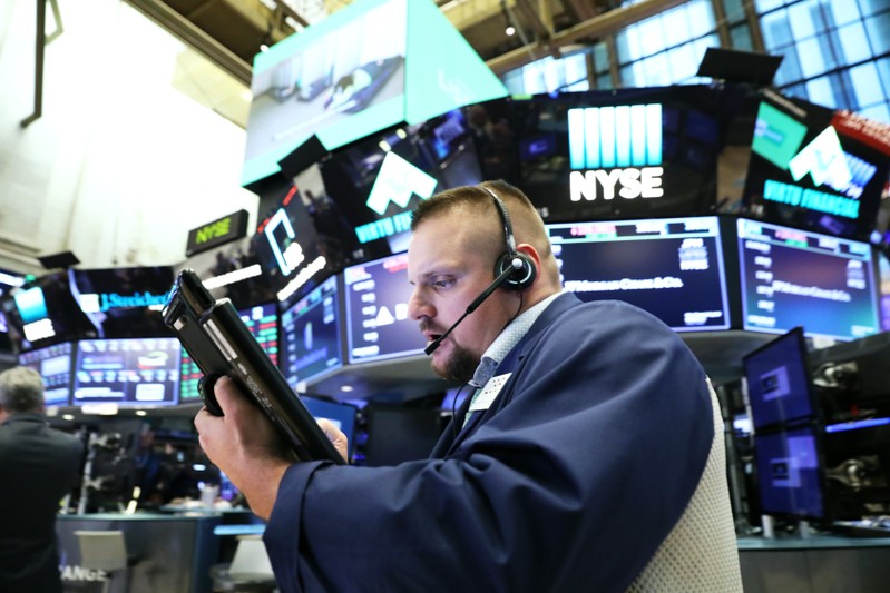 A trader works on the floor of the New York Stock Exchange (NYSE) near the close of market in New York