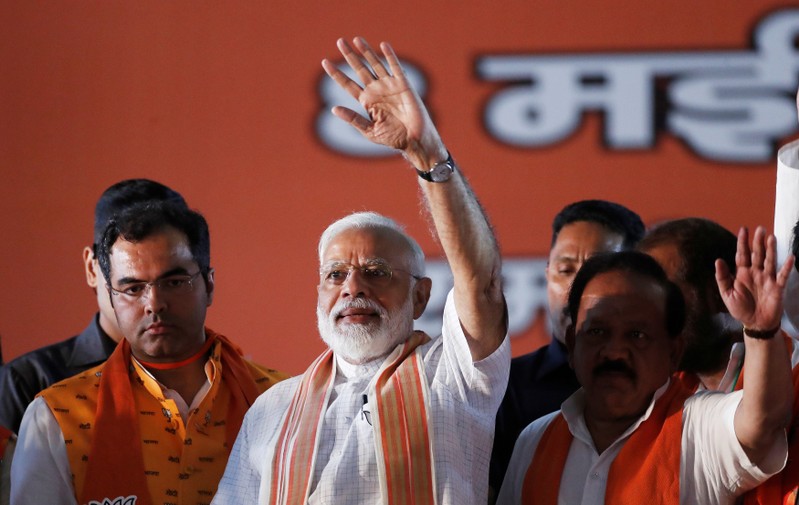 India's Prime Minister Narendra Modi waves towards his supporters during an election campaign rally in New Delhi