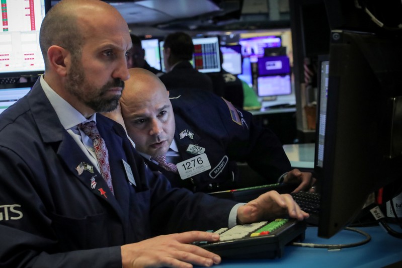 Traders work on the floor at the NYSE in New York