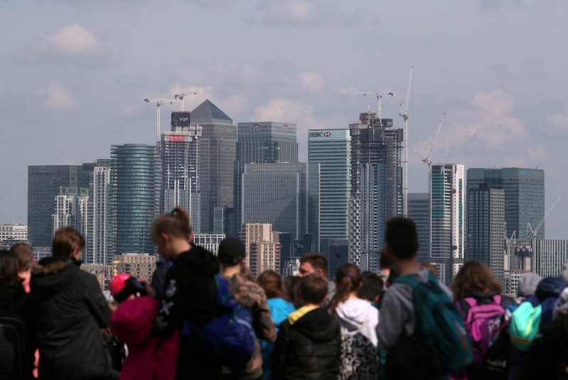 The Canary Wharf financial district is seen from Greenwich Park in London