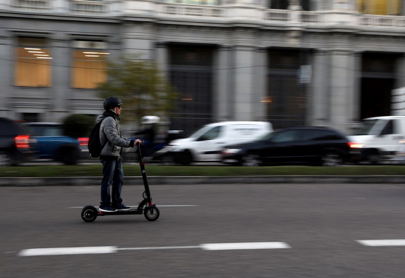 FILE PHOTO: A man rides an electric scooter in Madrid