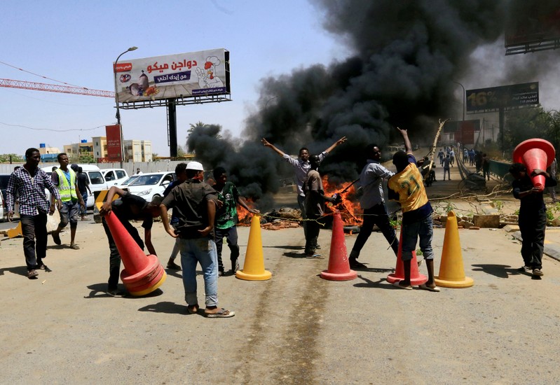 FILE PHOTO: Sudanese protesters burn tyres and barricade the road leading to al-Mek Nimir Bridge crossing over Blue Nile; that links Khartoum North and Khartoum