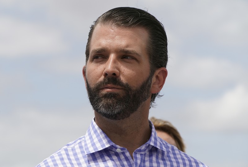 FILE PHOTO: Donald Trump Jr. listens to his father U.S. President Trump during visit to Lake Okeechobee in Canal Point, Florida