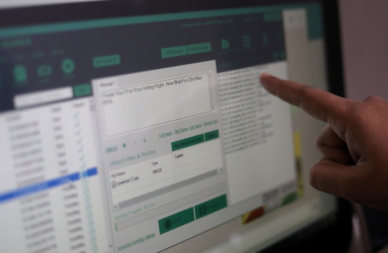 Rohitash Repswal shows a software tool that appears to automate the process of sending messages to WhatsApp users, on a screen inside his office in New Delhi