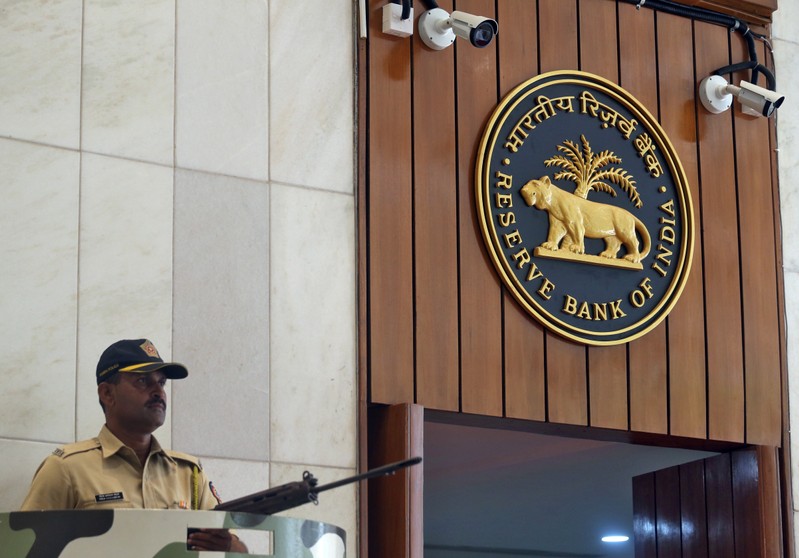 FILE PHOTO: A policeman stands guard at the entrance of the Reserve Bank of India headquarters in Mumbai