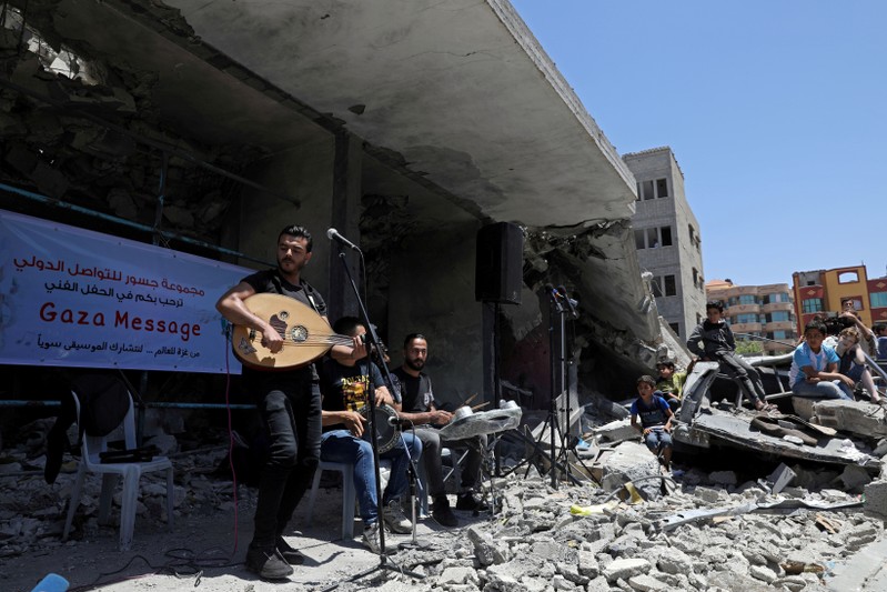 Palestinian singer performs during a musical event calling to boycott the Eurovision Song Contest hosted by Israel, in Gaza City