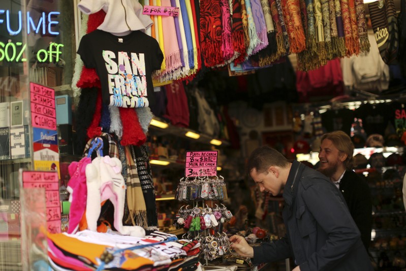 FILE PHOTO: Shoppers look over items at a souvenir store in San Francisco