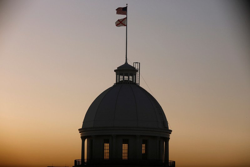 The U.S. Flag and Alabama State Flag fly over the Alabama Governor's Mansion as the state Senate votes on the strictest anti-abortion bill in the United States at the Alabama Legislature in Montgomery