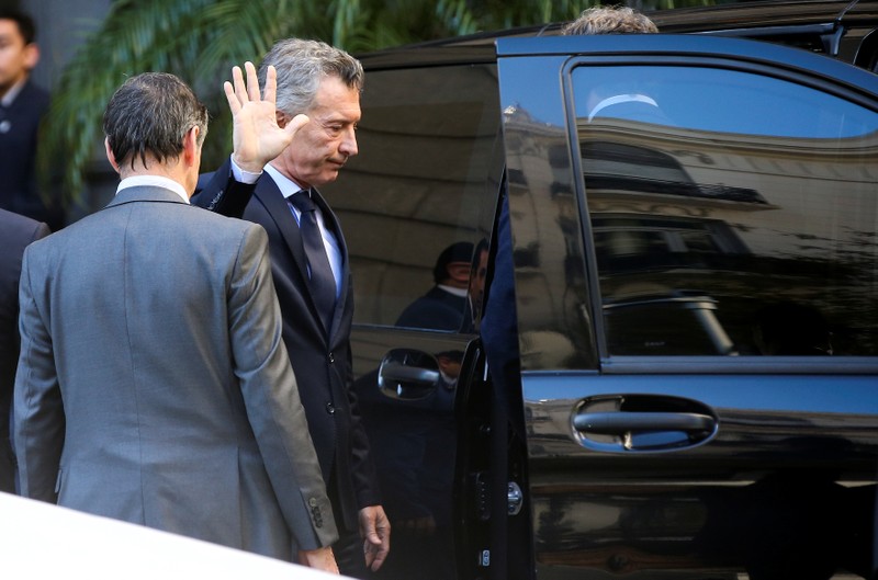 FILE PHOTO: Argentina's President, Mauricio Macri, waves to the press after attending the wake of lawmaker Hector Olivares, inside the National Congress in Buenos Aires