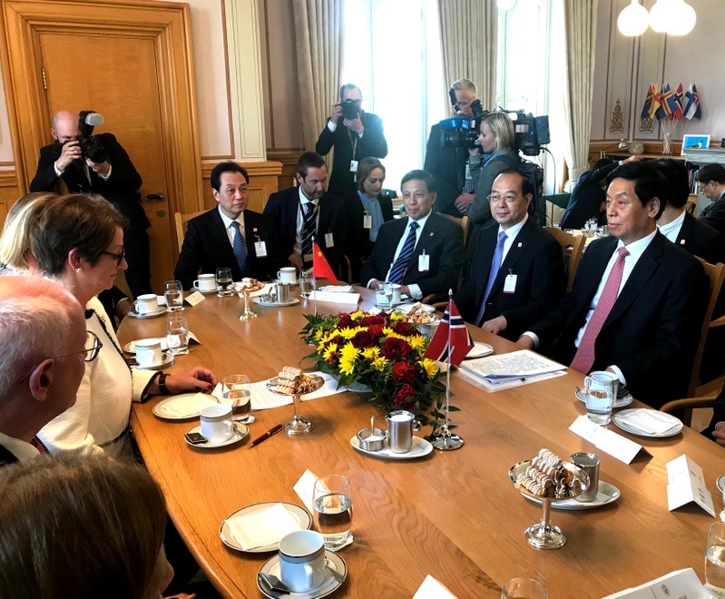 Chairman of China's Standing Committee of the National People's Congress Liu Zhanshu listens to President of the Norwegian Parliament Troen in Oslo