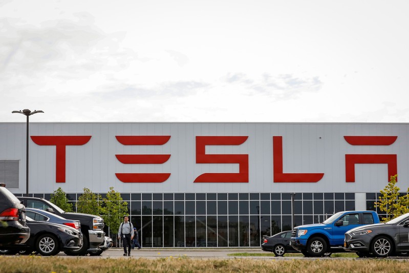 FILE PHOTO: A worker is seen outside the Tesla Inc. Gigafactory 2, which is also known as RiverBend, a joint venture with Panasonic to produce solar panels and roof tiles in Buffalo, New York