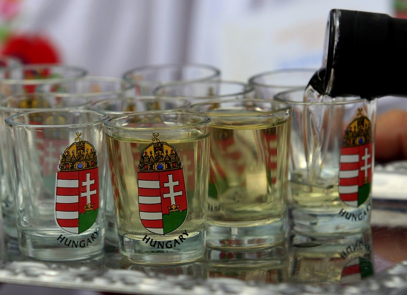 A man fills up glasses with 'palinka', a Hungarian fruit brandy, during the International Wheat Harvest Festival in Opalyi