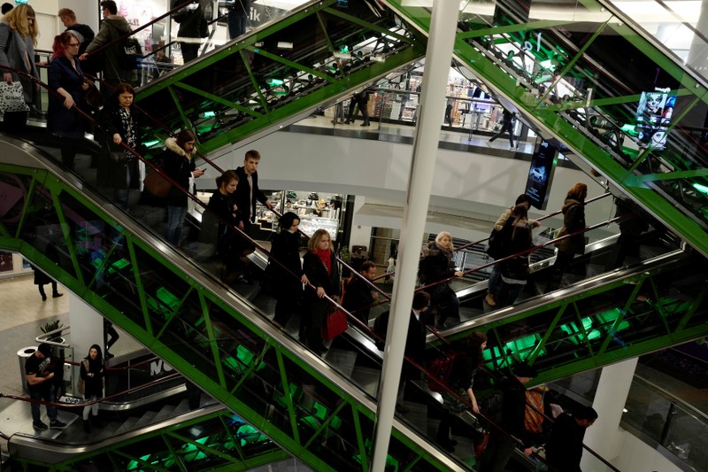 Shoppers use escalators as they visit a shopping mall in Warsaw