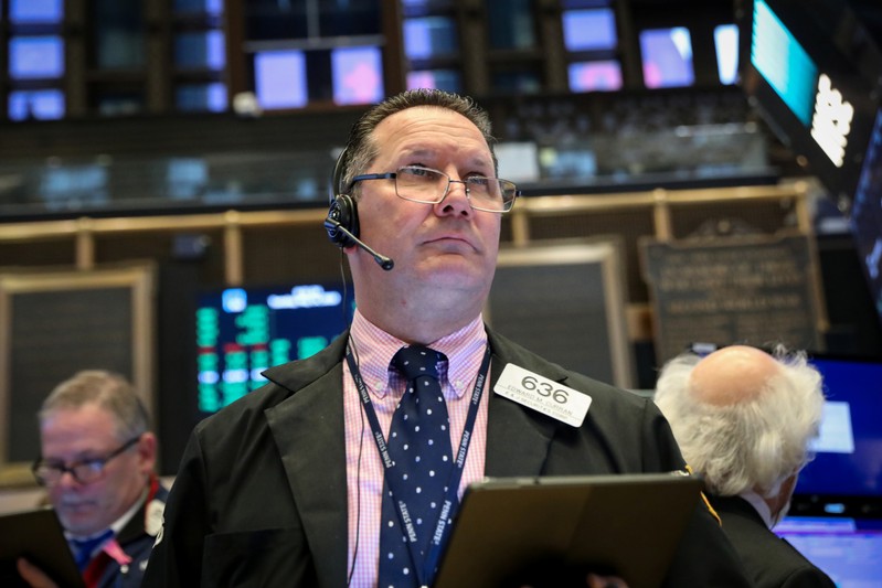 Traders work on the floor at the NYSE in New York