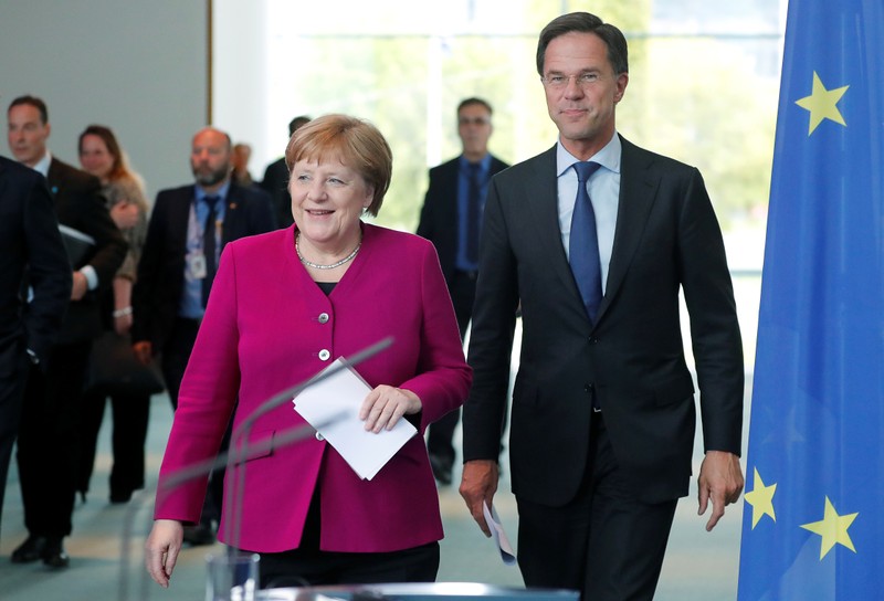 German Chancellor Merkel and Dutch PM Rutte arrive for a news conference at the Chancellery in Berlin