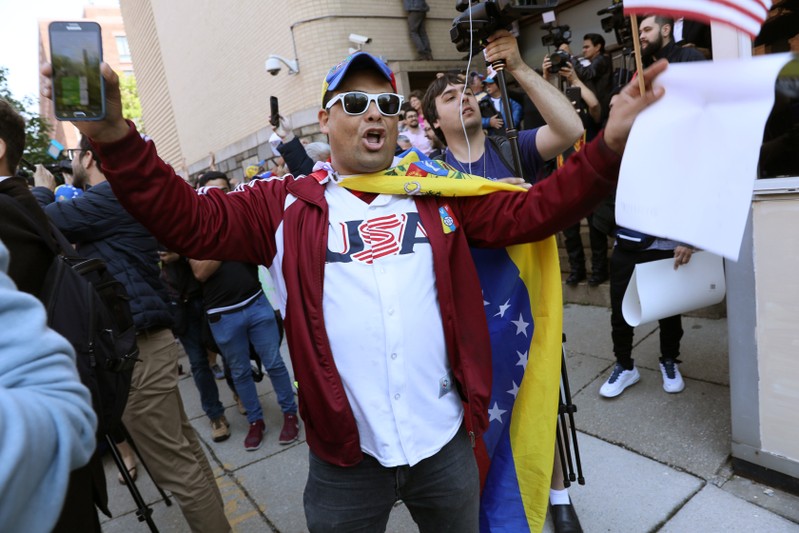 Guaido supporters celebrate outside the Venezuelan embassy during police raid in Washington