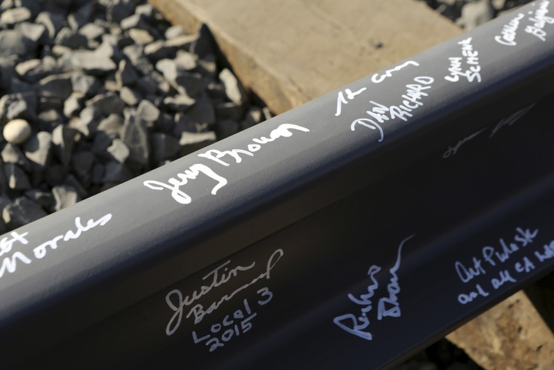 FILE PHOTO - California Governor Jerry Brown's name and others are pictured on a railroad rail after a ceremony for the California High Speed Rail in Fresno, California January 6, 2015.