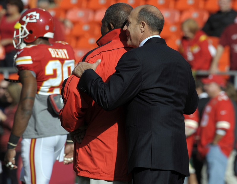 FILE PHOTO: Kansas City Chiefs head coach Romeo Crennel is hugged by general manager Scott Pioli before the start of their NFL game against the Carolina Panthers
