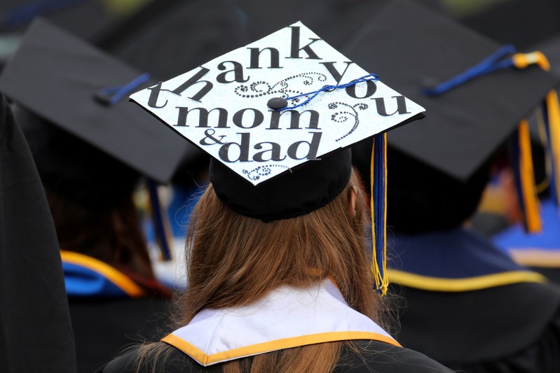 FILE PHOTO: Messages and artwork are pictured on the top of the caps of graduating students during their graduation ceremony at UC San Diego in San Diego