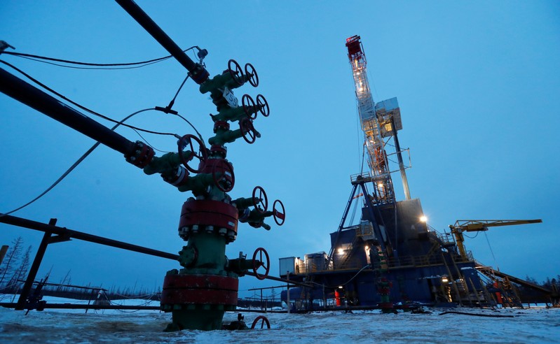 FILE PHOTO: A view shows a well head and a drilling rig in the Irkutsk Oil Company-owned Yarakta Oil Field in Irkutsk Region