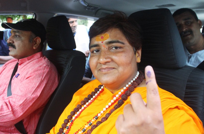 Pragya Singh Thakur, leader of ruling Bharatiya Janata Party (BJP), shows her ink-marked finger after casting her vote, outside a polling station in Bhopal