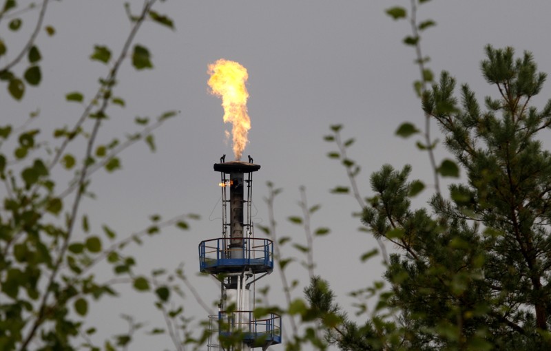 A flame burning natural gas is seen at an oil refinery located on a branch of the Druzhba oil pipeline, which moves crude through the pipeline westwards to Europe, near Mozyr