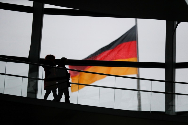 FILE PHOTO: Visitors walk inside the glass dome of the Reichstag building