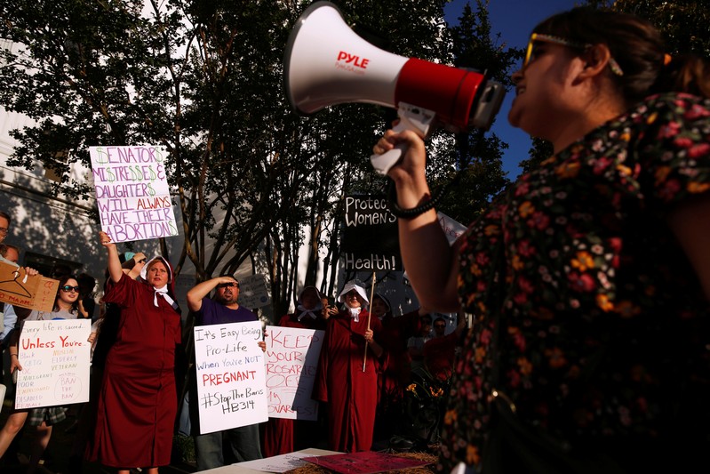 FILE PHOTO - Pro-choice supporters protest in front of the Alabama State House as Alabama state Senate votes on the strictest anti-abortion bill in the United States at the Alabama Legislature in Montgomery