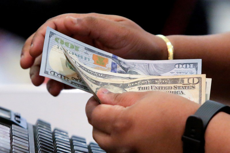 FILE PHOTO: A cashier handles money in Macy's Herald Square in Manhattan