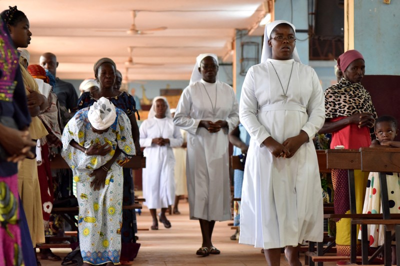 Catholic nuns attend a church service at the cathedral of Our Lady of Kaya in the city of Kaya