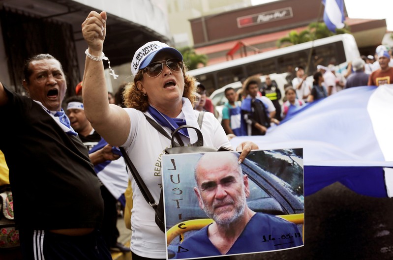 A Nicaraguan living in Costa Rica holds a portrait of U.S. citizen Eddy Montes while protesting in support of him in front of the Nicaragua Embassy in San Jose