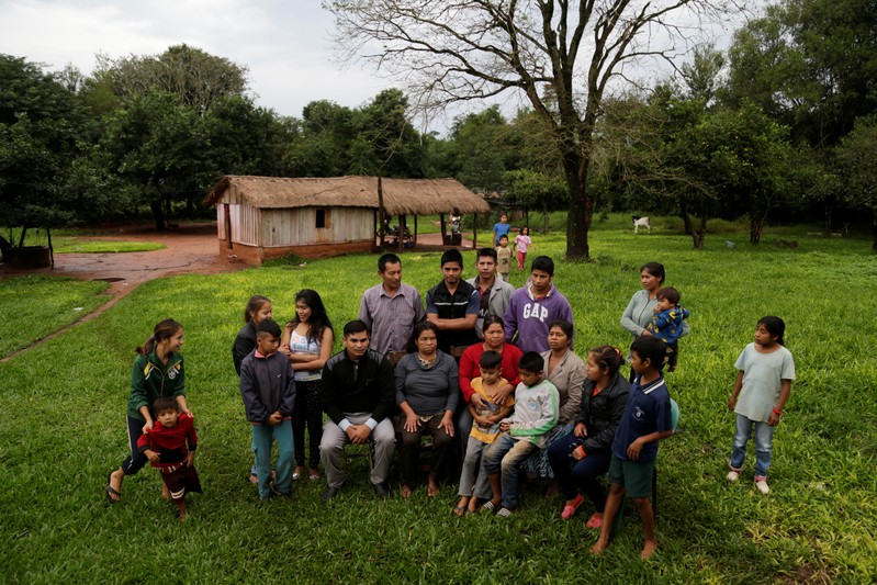 Community leader Cornelia Flores poses for a photograph with community members, in Isla Jovai Teju