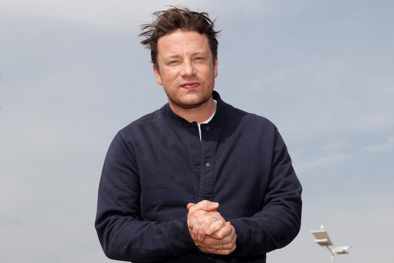 Chef Jamie Oliver poses during a photocall at the annual MIPCOM television programme market in Cannes
