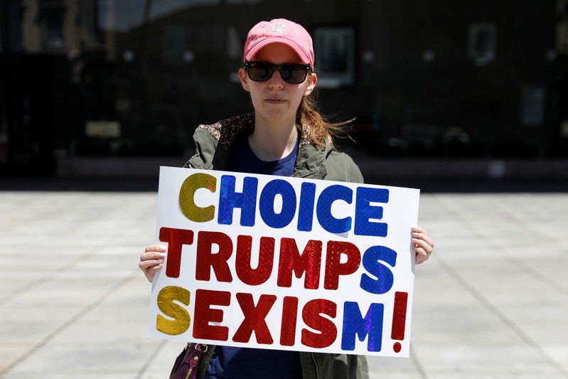 Rachel Prager, 34, poses with a sign against new restrictions on abortion passed by legislatures in eight states including Alabama and Georgia, in New York