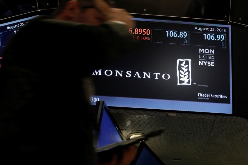 Trading information is displayed on a screen at the post where Monsanto Co. is traded on the floor of the New York Stock Exchange (NYSE) in New York City