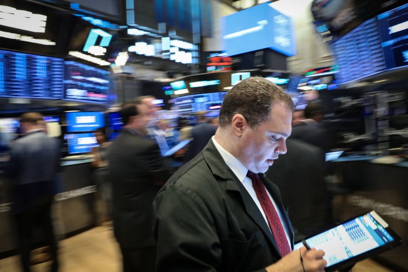 Traders work on the floor at the NYSE in New York