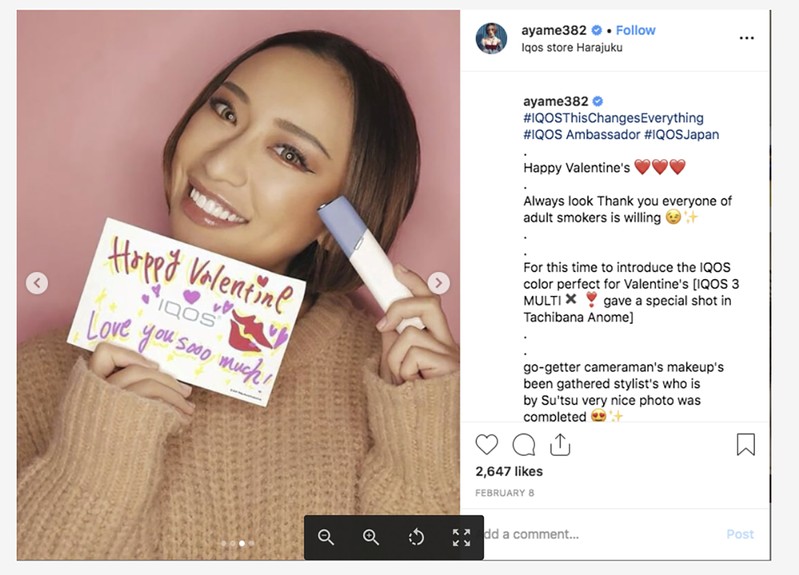 FILE PHOTO: Ayame Tachibana, a 27 year old Japanese model shows off a Valentine’s Day card for the iQOS