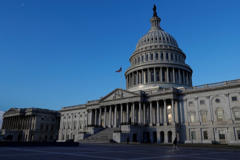 FILE PHOTO: People walk by the U.S. Capitol building in Washington