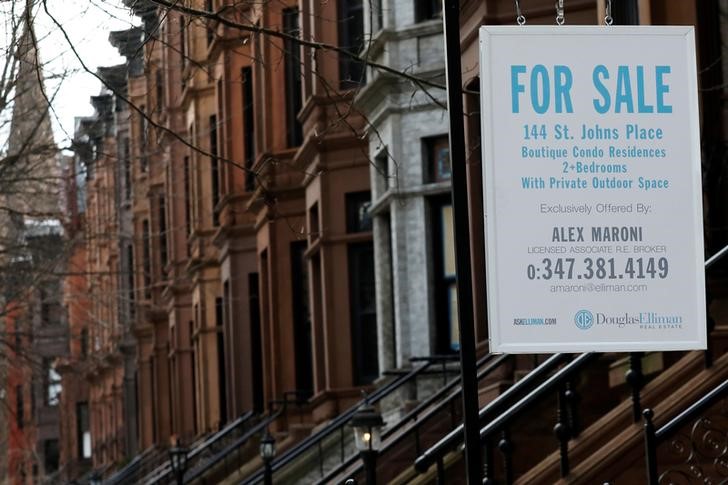 FILE PHOTO: A real estate sign hangs in front of a townhouse in Brooklyn, New York